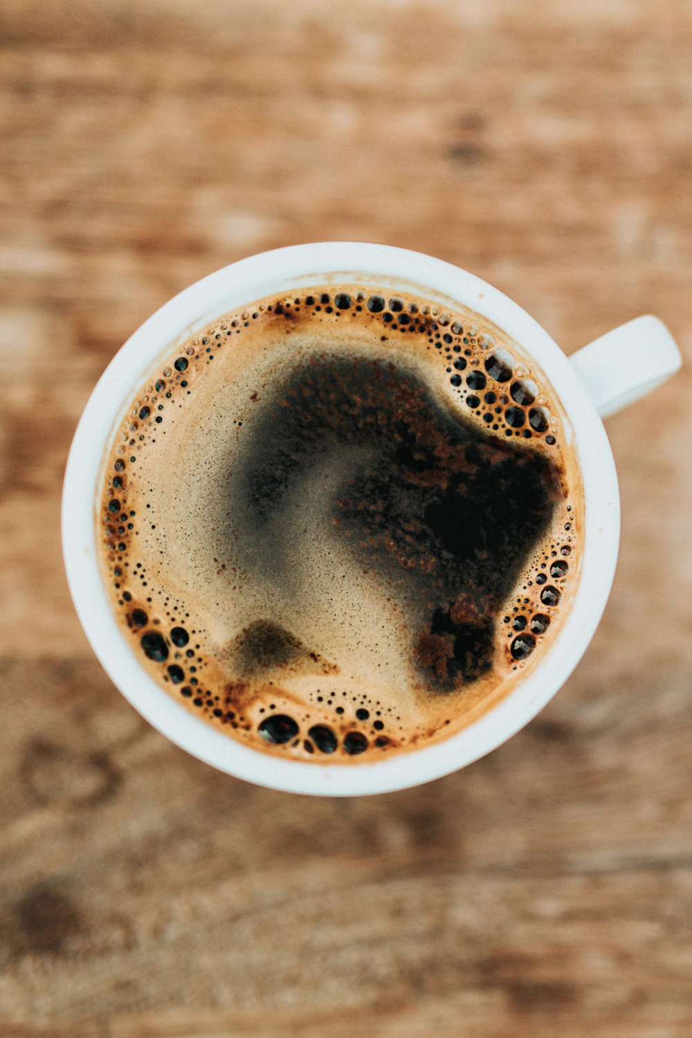 Gentle morning sunlight with hands holding a warm mug, reflecting grounding, warmth, and recovery